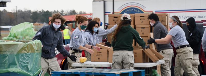 AmeriCorps volunteers staff one of the pickup locations Nov. 23 at Crossroad Community Church near Georgetown. Long lines of vehicles waited to be loaded with boxes to take back to their communities, soup kitchens and organizations for distribution to 10,000 people in Mountaire Farms’ Thanksgiving for Thousands project. RON MACARTHUR PHOTOS
