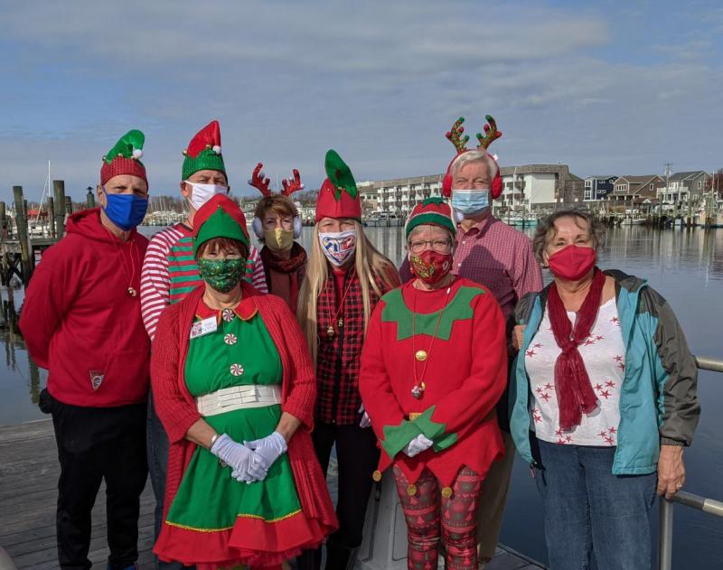 Pictured in front row are the Elves of Unit 17 (l-r) Historian Nancy Bush, Auxiliary President Murt Foos and Vice President Gail Sellazzo. In back are City of Lewes Hospitality Ambassadors JGar Helling, Ed Bowe, Chamber of Commerce Executive Director Betsy Reamer, Robyn DelleMonache and Mayor Ted Becker. SUBMITTED PHOTO