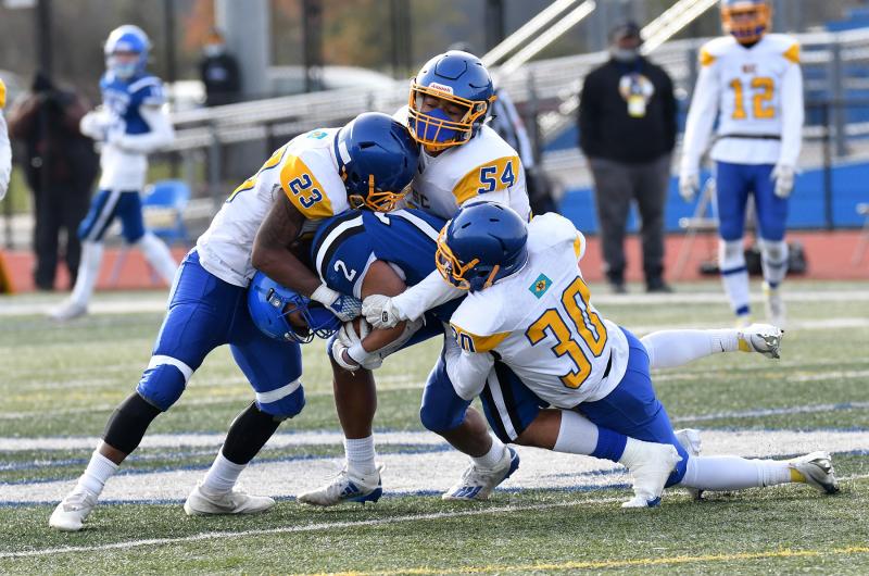 Central players (l-r) Skyler McVicker, Alton Dennis and K'Tai Tilley bring down Middletown’s Ben Martin.