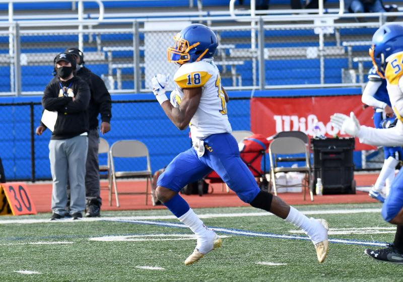 Phillip Stratton breaks through the line and sprints to the end zone to add a touchdown for the Knights.