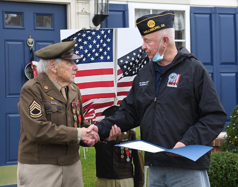 Oak Orchard/Riverdale American Legion Post 28 Commander Jim Beattie presents Tom Creekmore with a proclamation in honor of his service.