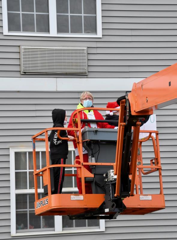 Richard Leighton moves the lift up to visit with his father, Tom, a resident of The Moorings at Lewes.