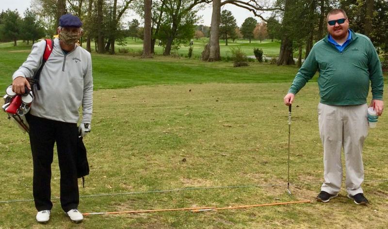 This photo from late April captures one of COVID-19’s effects on golf in 2020. The masked Fritz Schranck, left, took a lesson from Rookery Assistant Golf Pro Chris Osberg. Osberg was able to help with a swing issue despite the distancing shown by the two alignment poles between them. SUBMITTED PHOTO