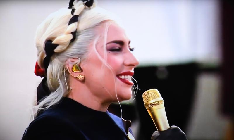 Lady Gaga, one of several celebrity performers taking part in the ceremony, sings the national anthem. SCREEN SHOT BY RON MACARTHUR