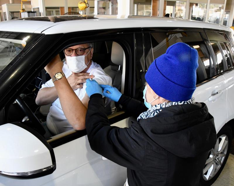 Walt Jones of Lewes rolls up his sleeve to get a vaccination administered by Beebe Healthcare nurse Stephanie Williams.