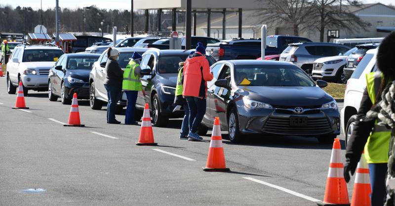 Lines are long all day as motorists wind through a series of four parking lots to reach the vaccination area.