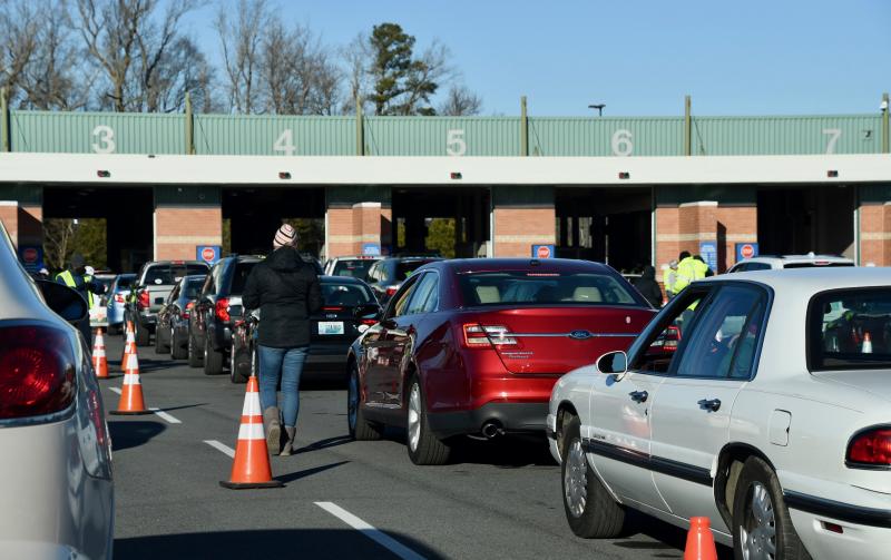 Cars prepare to enter the Georgetown DMV inspection lanes on the first day of a mass vaccination clinic.