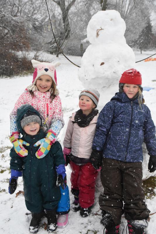 Showing off their snowman are (l-r) Jasper and Maybellene Willis and Azalea and Pepper Brittingham. NICK ROTH PHOTO