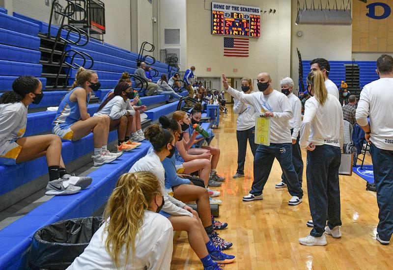 Cape head coach Pat Woods reviews the game plan during halftime.
