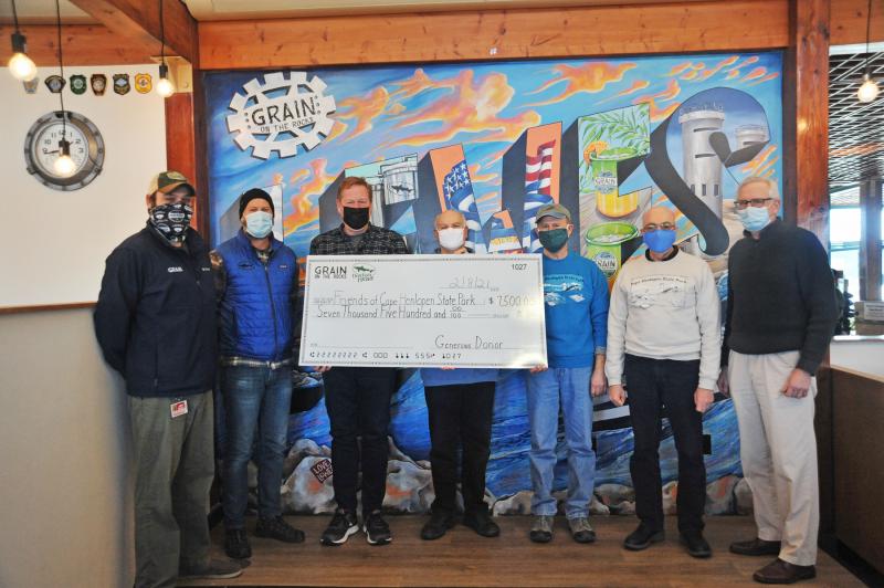 Dogfish Head and Grain recently donated $7,500 to the Friends of Cape Henlopen State Park. Shown are (l-r) Jason Meisner, Grain general manager; Mark Carter, Dogfish Beer & Benevolence director; Lee Mikles, Grain co-owner; John Bracco, president of Friends board; Ian Friedland, Friends board; Tony Baldino, Friends treasurer; and Rich Suszao, Friends board. NICK ROTH PHOTO