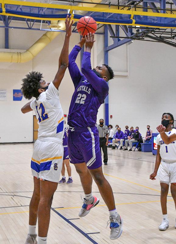 Royals forward Jayson Handy hits a deuce over Sussex Central’s Jalil LaSalle.