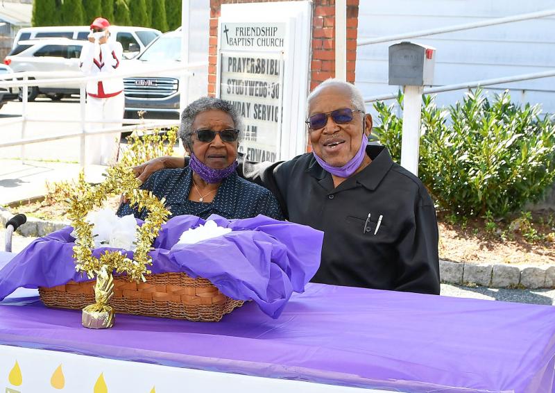 The Rev. George Edwards, right, and his wife Ardeth pose for a picture before the drive-by celebration.