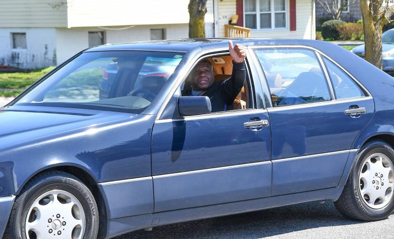 Former Cape coach and Lewes resident Bill Collick wishes the couple a happy birthday during the drive-by parade.
