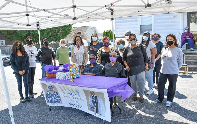 The Rev. and Mrs. George Edwards’ friends and family gather for fellowship after the drive-by birthday parade. Shown in back are (l-r) Georgia Edwards Perry, Dalmita Johnson, Leon West, Vera Turner, Lisa Edwards, Isaiah Parsons, Seandra Parsons, Jennifer West, Janet West, Mary Turner, Hattie Bull, Christa Edwards, Doris Person, Stephanie Collick and (seated, background) Rosie Garrison. Seated in front are the Rev. George and Ardeth Edwards.