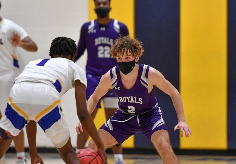 Royals guard Gabe Herling, right, plays tough defense on Central’s Dontae Spencer.