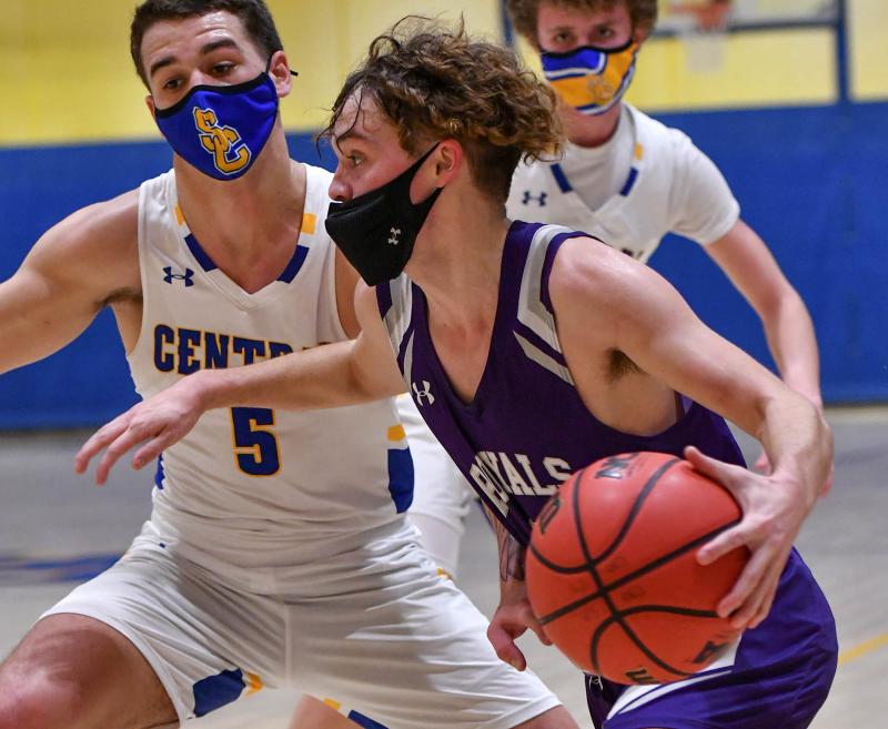 Royals sophomore guard Gabe Herling drives into the paint as Knights forward Chase Boyle plays defense.