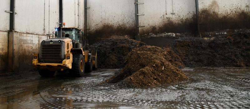 The composting process begins in a mixing building where poultry processing waste is trucked in and mixed with wood chips.