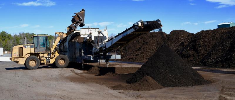 The finished compost material is screened to remove any pieces larger than three-eighths of an inch. The screened-out wood will be reused in the process at the first stage of mixing.