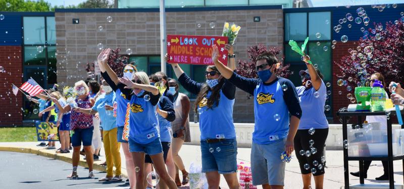 With schools closing the last two months of the 2020 school year, teachers and staff in the Cape Henlopen School District get creative to honor their fifth graders moving on to middle school. At Love Creek Elementary, on June 21, 2020, staff members gather outside the school during a drive-thru celebration.