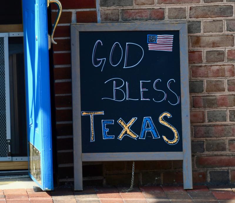 Michael Oxbrough, owner of Cafe on The Circle in Georgetown, has a sign in support of Texas in front of his restaurant. On March 10 in Texas, mandatory mask requirements will be lifted and businesses and restaurants can be open with no occupancy restrictions. Oxbrough, an opponent of government-mandated restrictions, defied state officials and offered outdoor seating in May when restaurants were ordered to close their doors allowing carryout and delivery services only.