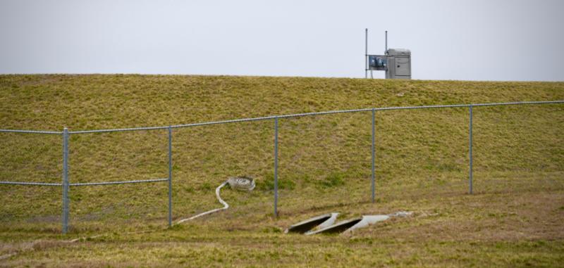 A large berm serves as a buffer between Isaacs Road and a 90-million-gallon storage lagoon, which was constructed in Phase 1 of the Artesian project.
