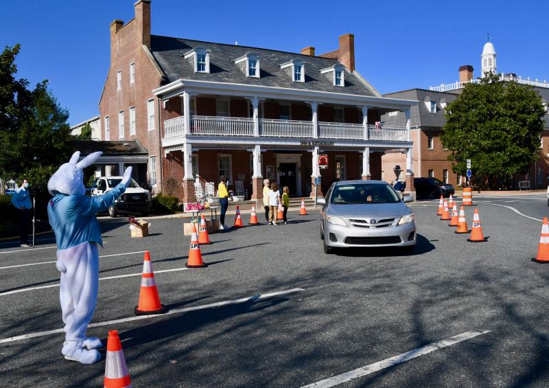In front of the Brick Hotel, the Easter Bunny waves to passersby as they drive around The Circle in Georgetown. Thousands of eggs filled with candy were given away March 27 in the event sponsored by the Greater Georgetown Chamber of Commerce and Town of Georgetown. RON MACARTHUR PHOTOS