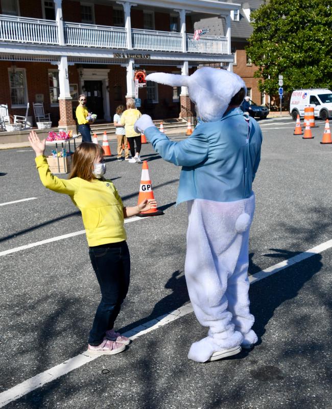 Lucy Dye of Georgetown does the chicken dance with the Easter Bunny thanks to the music being played on The Circle by Sky Brady.