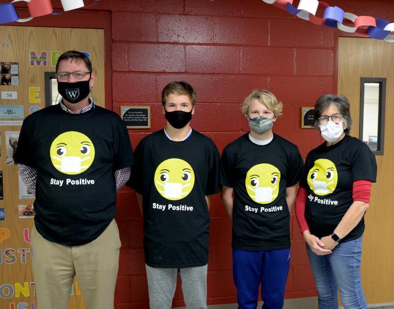 Showing off their Stay Positive T-shirts are (l-r) WPS Head of School Dr. John McDonald, Hunter and Dylan Simons, and WPS technology teacher Nancy Raskauskas, who has been an inspirational guiding force helping the boys in their mission.