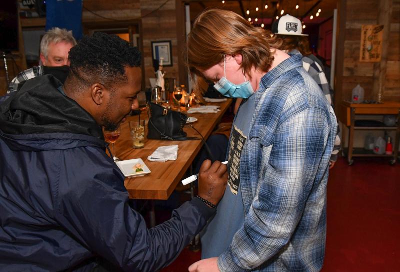 Alex Fitzkee, right, of the local group Hope for Success, gets his shirt autographed by guest performer Robert Randolph.