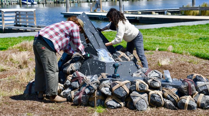Emmett Ryan and artist Rachel Mica Weiss place some of the 500 stones – weighing 8,000 pounds total – at the Lewes Public Arts Committee-sponsored art display in Canalfront Park.