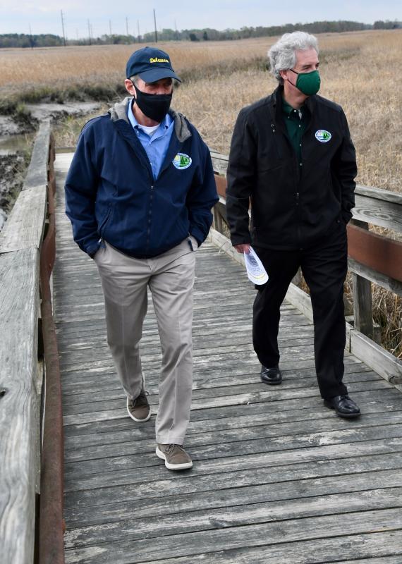 Gov. John Carney, left, and DNREC Secretary Shawn Garvin stroll on the St. Jones Reserve marsh boardwalk.