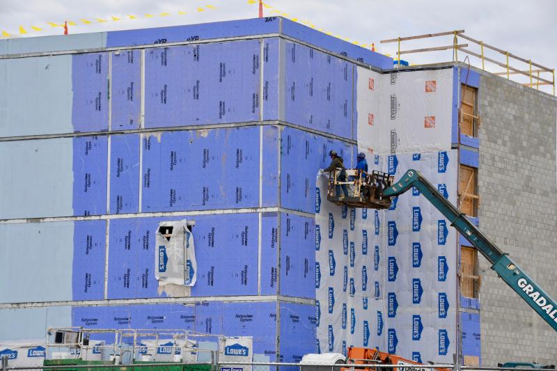 Workers go on a lift as they work at the site of a new Hyatt House off Marsh Road near Lewes. The hotel is scheduled to open this summer.