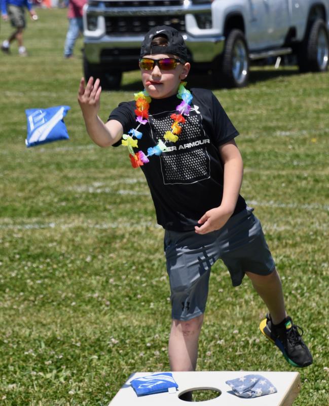 Zander Kalafut of Wilmington throws a bean bag during a cornhole tournament sponsored by Schell Brothers.