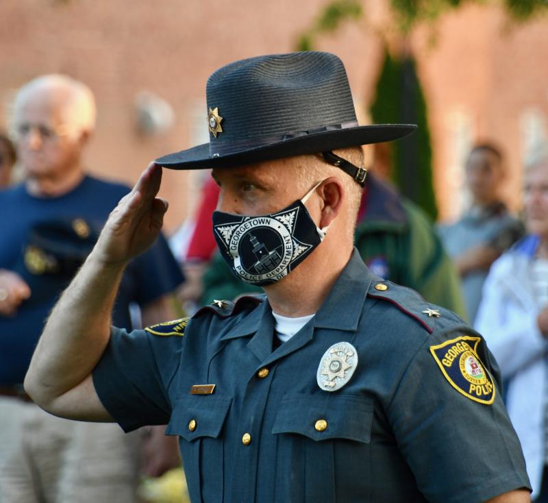 Georgetown Police Chief R.L. Hughes, a retired DSP officer and president of the Sussex County Chiefs Association, stands at attention during the rally.