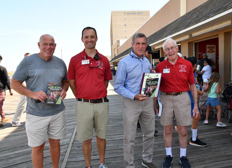 Displaying the book “Land of Fun: The story of an Old-Fashioned Amusement Park for the Ages” are Rep. Pete Schwartzkopf, Funland owner Chris Darr, Gov. John Carney and Al Fasnacht.