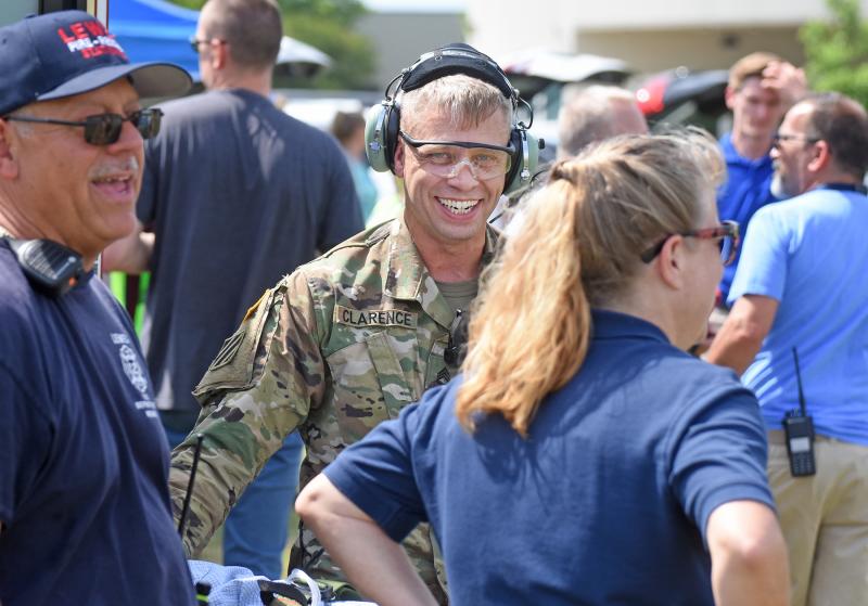 Staff Sgt. Dave Clarence shares a laugh with Tony Esposito and Pam McClanahan of Lewes Fire Department EMS during some downtime.