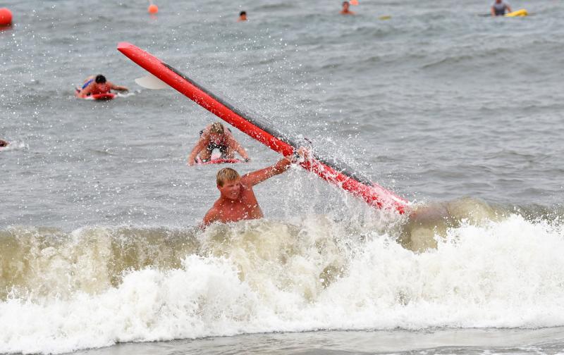 Middlesex Beach Patrol member Mitch McGee fights off a wave during the iron man contest. He broke two fingers during the competition.