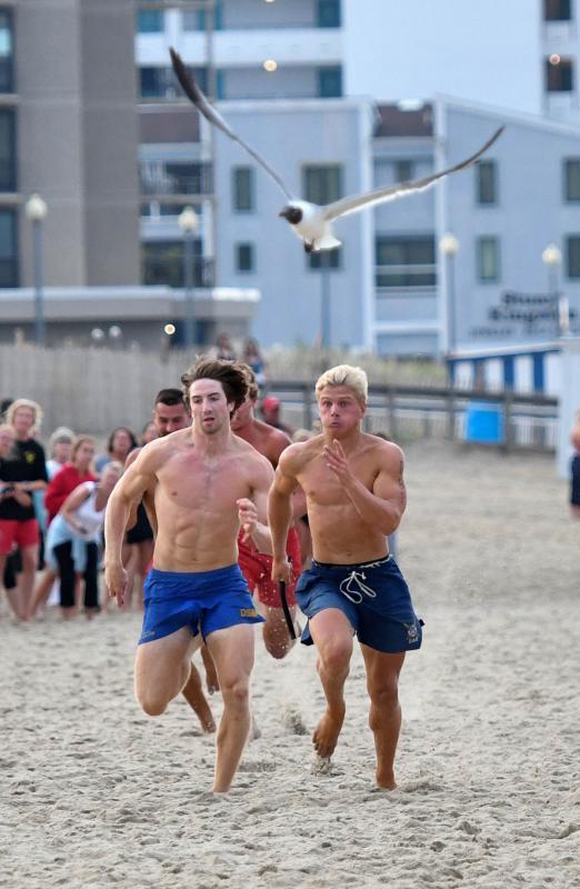 Delaware State Parks’ Ben Sobota, left, and Dewey Beach Patrol’s C.J. Fritchman sprint the first leg of the 4-by-200 soft sand relay.