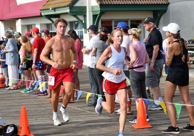 Jen Cawthern exits the transition area. She teamed with Grace Brokaw to place first in the female team division with a time of 32:50.8.
