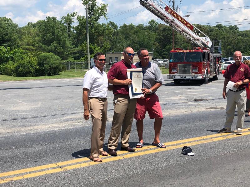 Rep. Steve Smyk, R-Milton, left, and Sen. Ernie Lopez, R-Lewes, right, present proclamations from Delaware’s House of Representatives and Senate to Milton Fire Department President Brian Reynolds Jr.