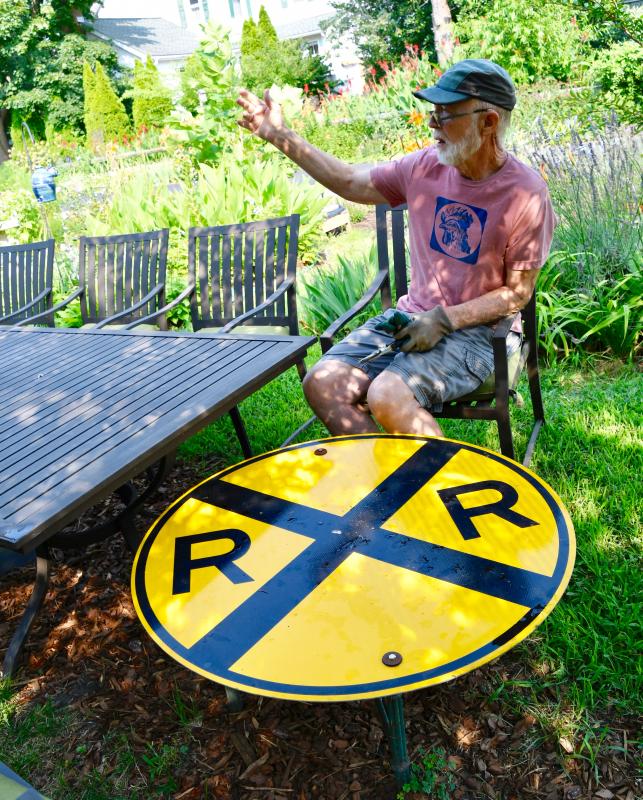 “Garcon, Garcon,” calls out Bill Arvidson from his seat at the neighborhood Railroad Cafe in his backyard.