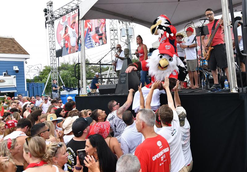 Washington Nationals mascot Screech connects with the people around the stage while Washington Capitals mascot Slapshot entertains with Kristen & the Noise. DAN COOK PHOTO