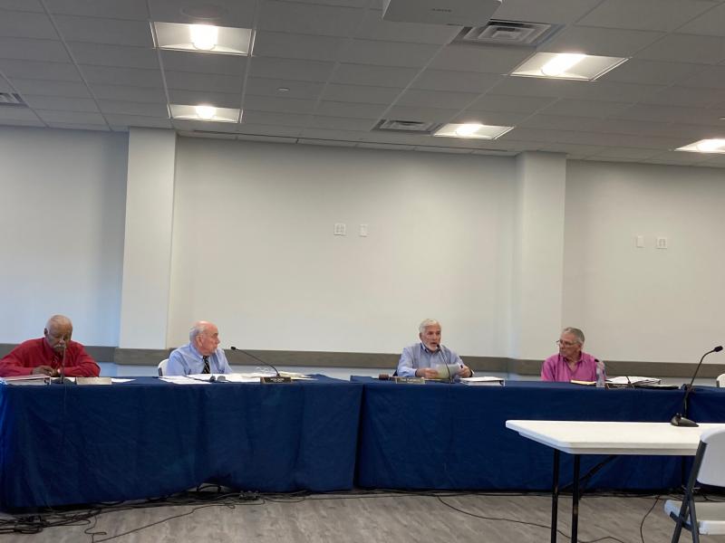 Milton Town Council members (l-r) Larry Savage, Sam Garde, Mayor Ted Kanakos and Rich Baty debate during their Aug. 11 special meeting and later decide to uphold the Milton Planning and Zoning Commission’s decision to grant a special permitted use to Verizon for a 140-foot cell tower at 210 Front St. RYAN MAVITY PHOTO