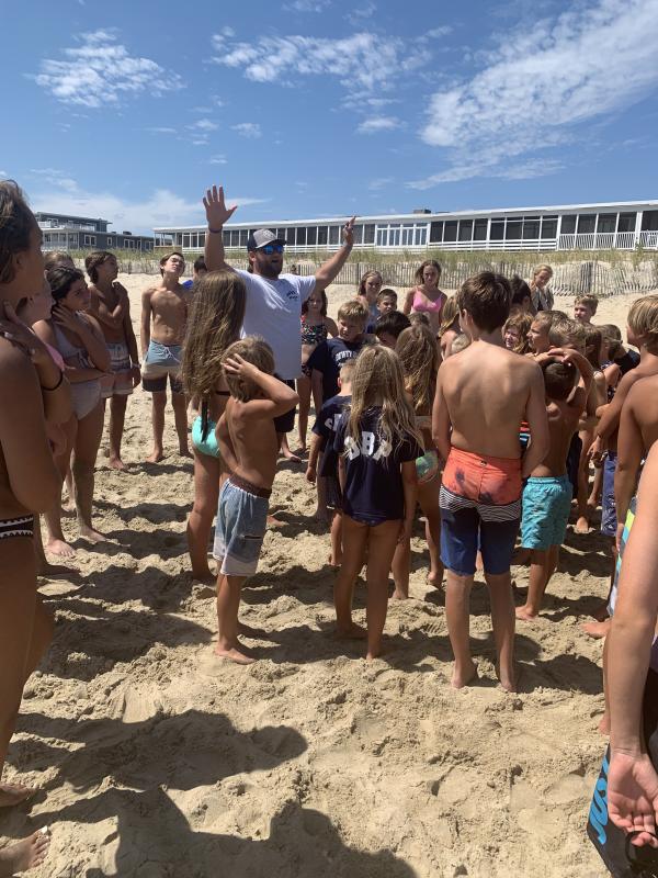 Liam Zolper, a Cape grad and current physical education major at Lynchburg College, helps run the junior lifeguard program. He is shown giving an end-of-season speech to the participants.