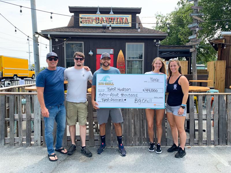 The Tyler Palooza fundraiser held July 27 at Big Chill Surf Cantina netted $44,000 to aid in the recovery of Tyler Hudson, owner of Dewey Beach Surf Shop, who was injured in a July 16 traffic collision. Pictured during the check donation are (l-r) Mike Ridings, Matt Garbutt, AJ Borerro, Maddie Kelly and Rachael Richardson. LAINE DUPONT PHOTOS
