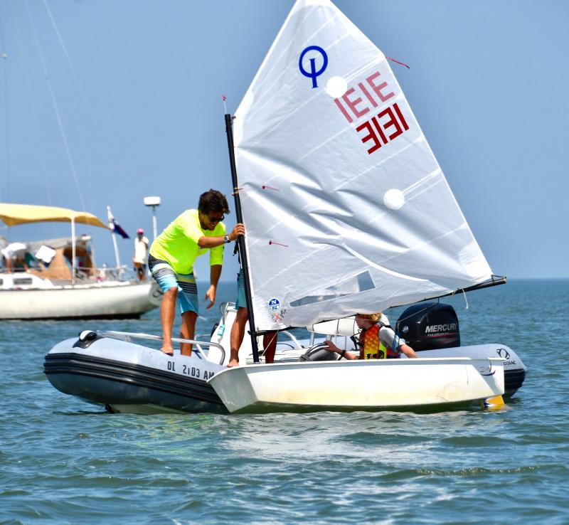 Lewes Yacht Club sailor Henry Cummins gets some mast adjustments from coach Tyler Myers between Optimist races.