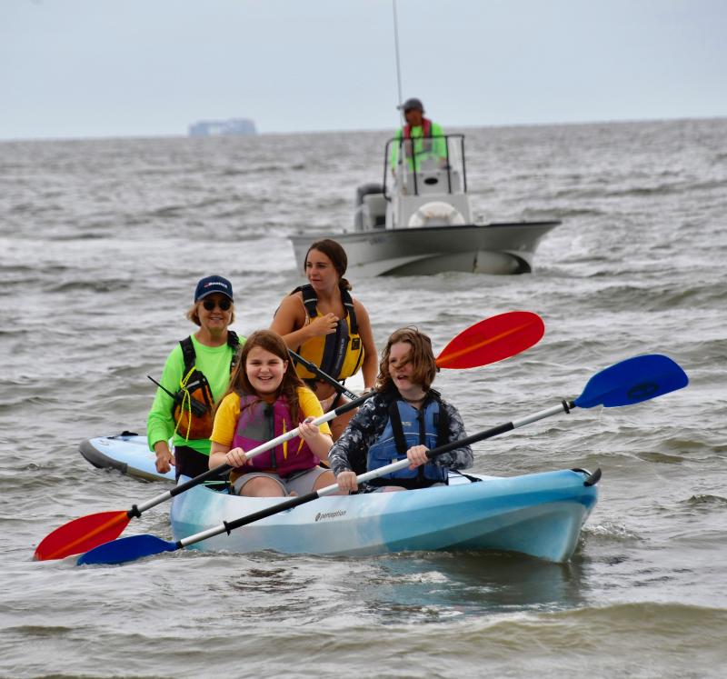 Under the watchful eyes of volunteer Jenny Hopkins and LYC sailing instructor Sarah Krajewski, kayakers Hayle Troyer and Halie Harman-Strike head for the beach.