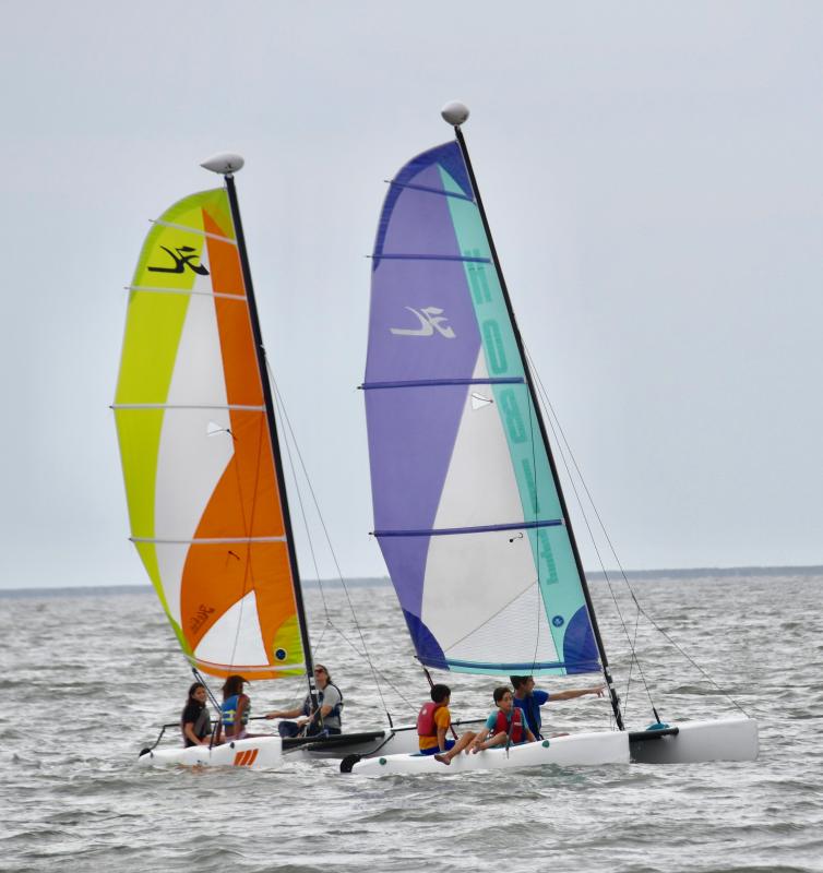 Hobie Cats with four YMCA Explorers on board sail in Delaware Bay during the Lewes Yacht Club’s Sailing Outreach Day.