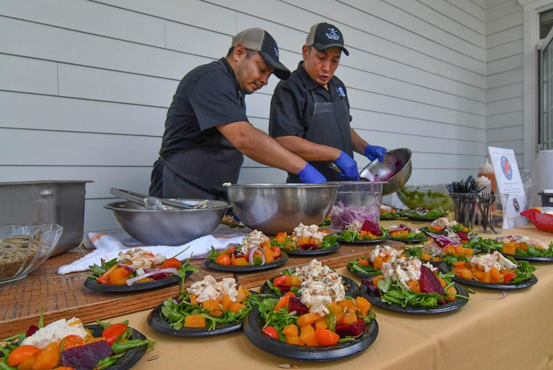 Bernabe Arquecs, left, and Jesus Hernandez make some tasty plates from Fins.