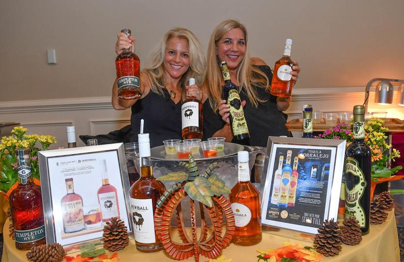 Kim Derbyshire, left, and Amy Herz work the Breakthru Beverage Group booth.